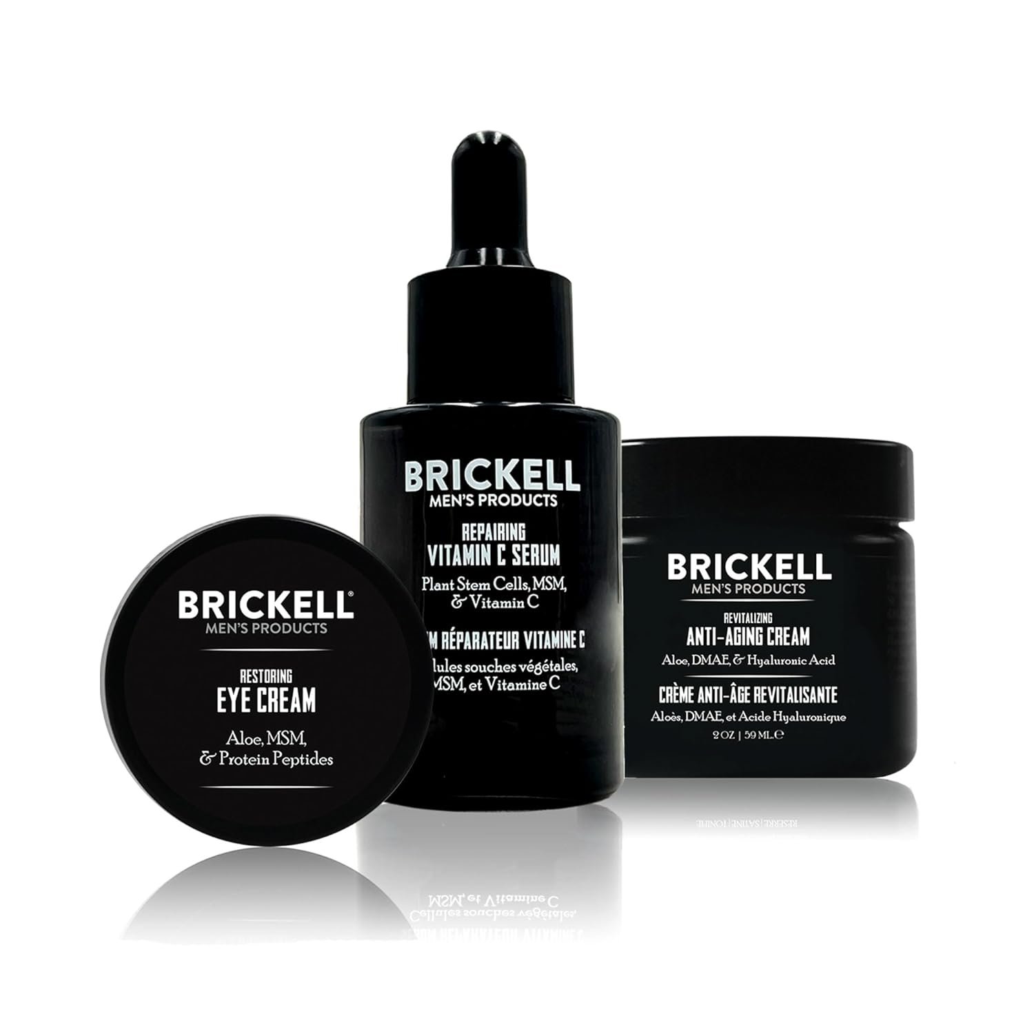 Vitamin C and peptide anti-aging skincare set for men including serum, night cream, and eye cream on minimal white background — view 1